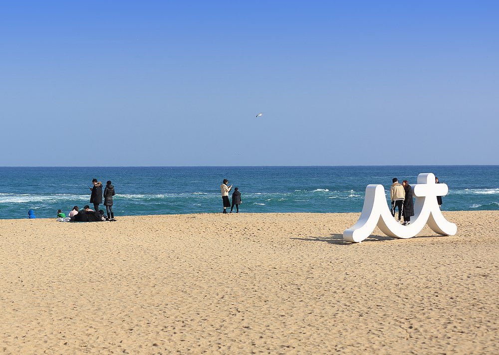 Blue water and sandy shoreline at Sokcho Beach