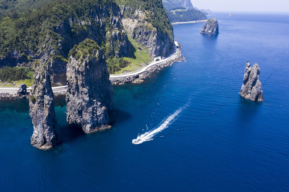Winding coastal road beneath steep cliffs on Ulleungdo Island