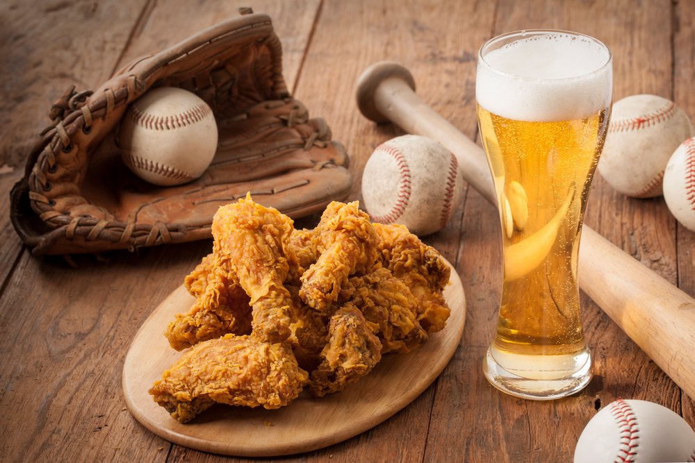 Korean fried chicken, beer, and stadium snacks arranged at seats during a baseball game
