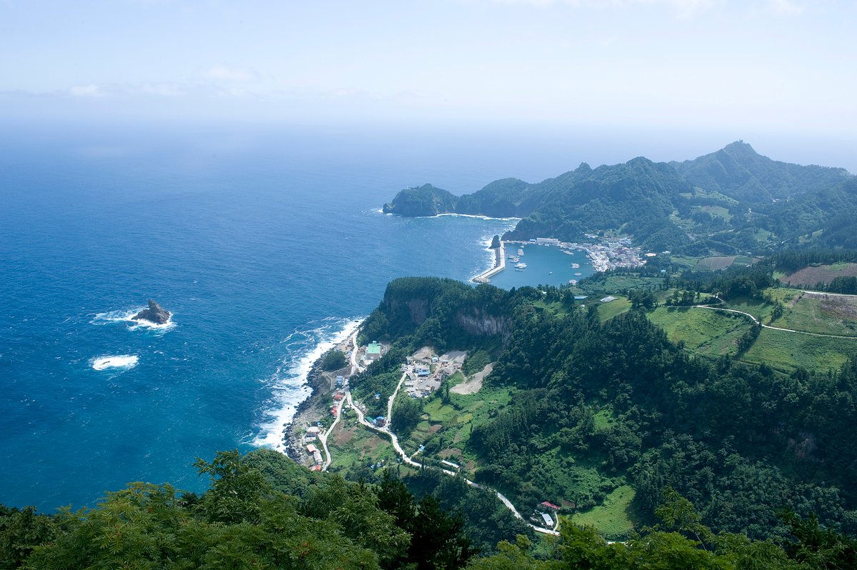 Steep green cliffs rising above the blue sea around Ulleungdo Island